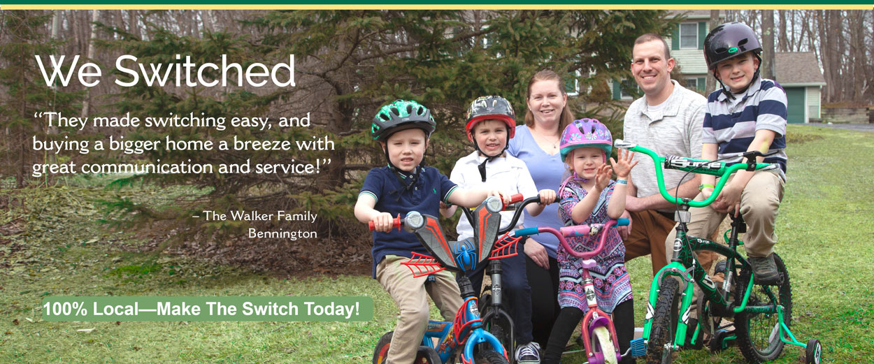 family with kids on bikes with helmets