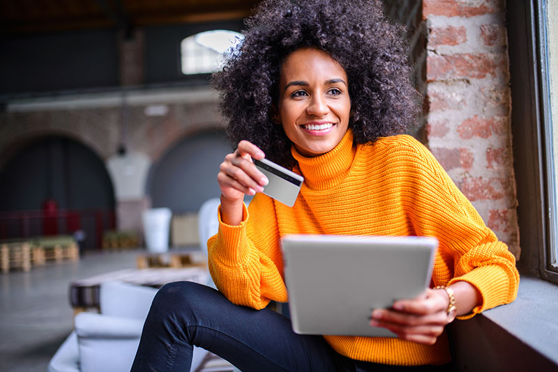 Woman holding ipad and credit card